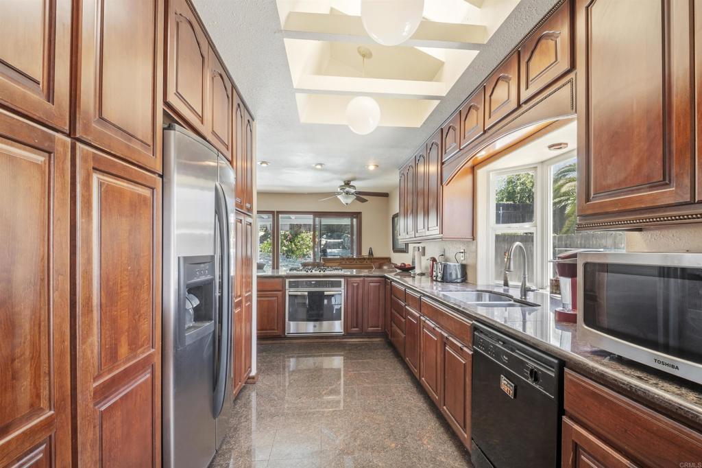 9715 Kenesaw Court Santee, CA 92071 - Photo 16 of 36 a large white kitchen with a large window