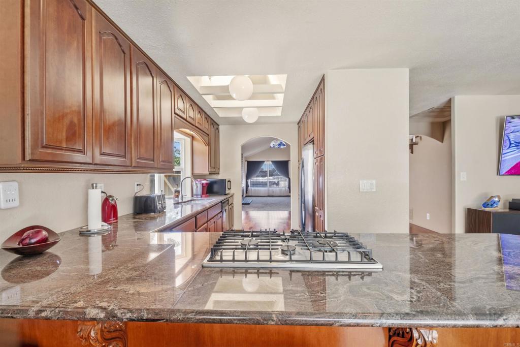 9715 Kenesaw Court Santee, CA 92071 - Photo 17 of 36 a kitchen with stainless steel appliances granite countertop a stove and cabinets