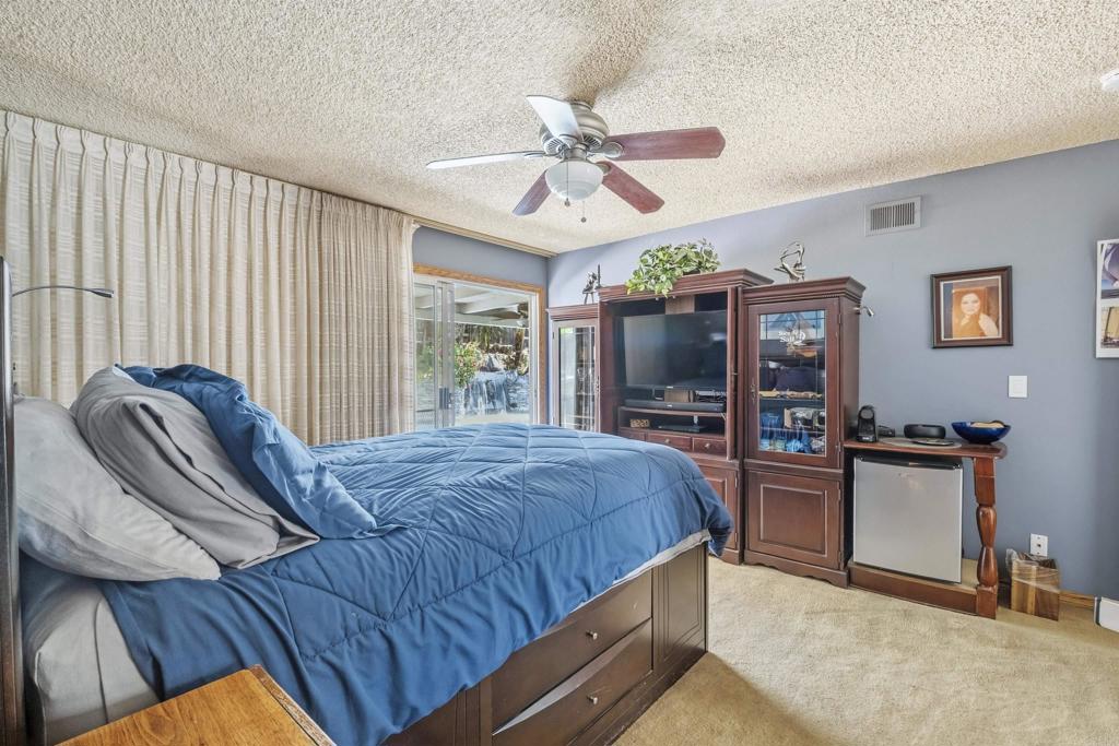 9715 Kenesaw Court Santee, CA 92071 - Photo 19 of 36 a bedroom with a bed and a chandelier