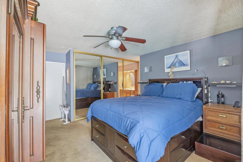 9715 Kenesaw Court Santee, CA 92071 - Photo 21 of 36 a bedroom with a bed and a chandelier