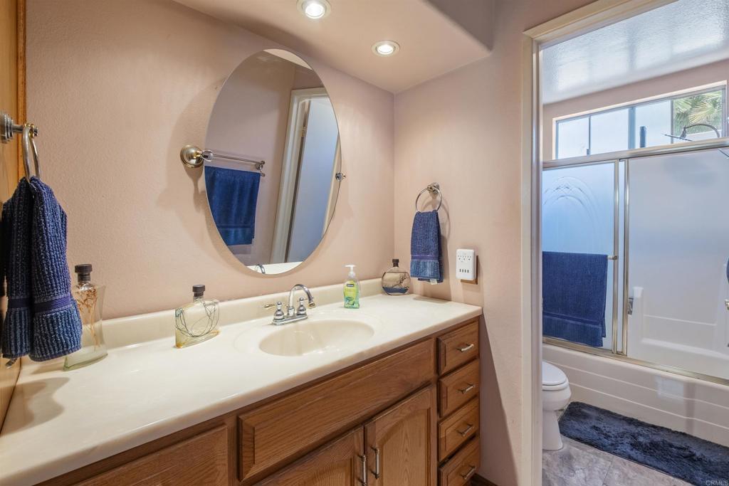 9715 Kenesaw Court Santee, CA 92071 - Photo 22 of 36 a bathroom with a double vanity sink and a mirror