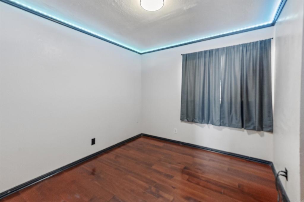 9715 Kenesaw Court Santee, CA 92071 - Photo 26 of 36 a view of an empty room with wooden floor and a window