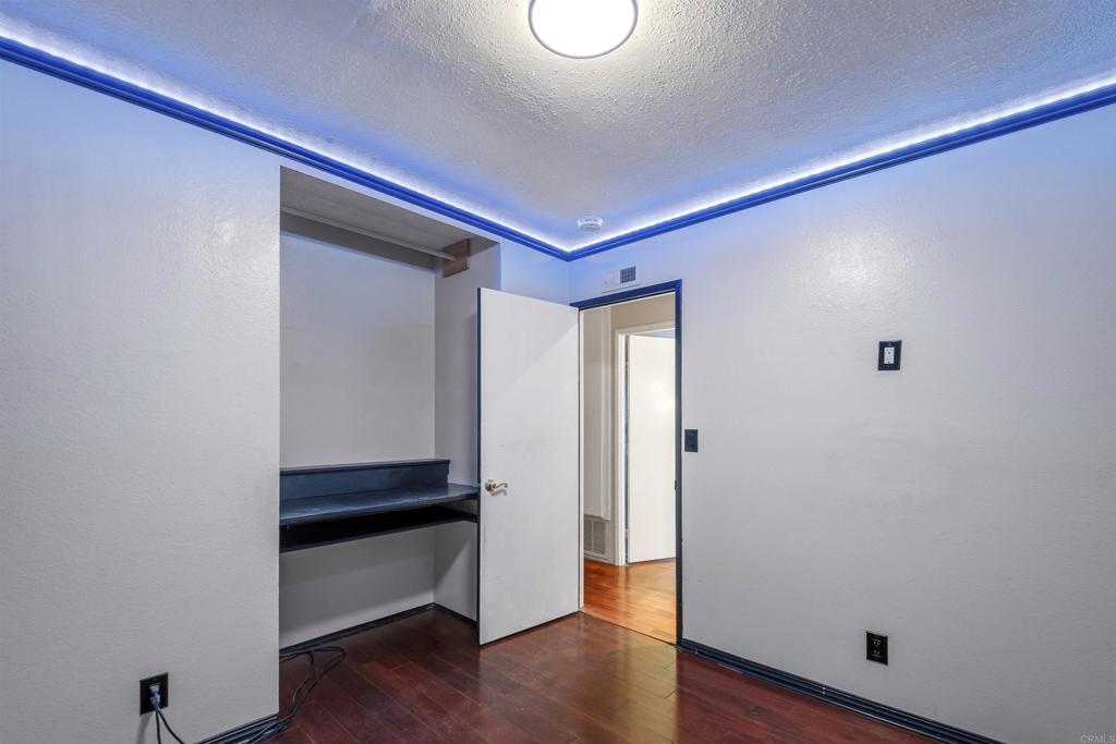 9715 Kenesaw Court Santee, CA 92071 - Photo 27 of 36 a room with wooden floor and white walls