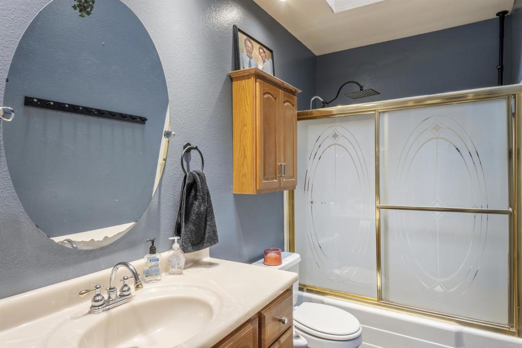 9715 Kenesaw Court Santee, CA 92071 - Photo 28 of 36 a bathroom with a sink toilet and shower