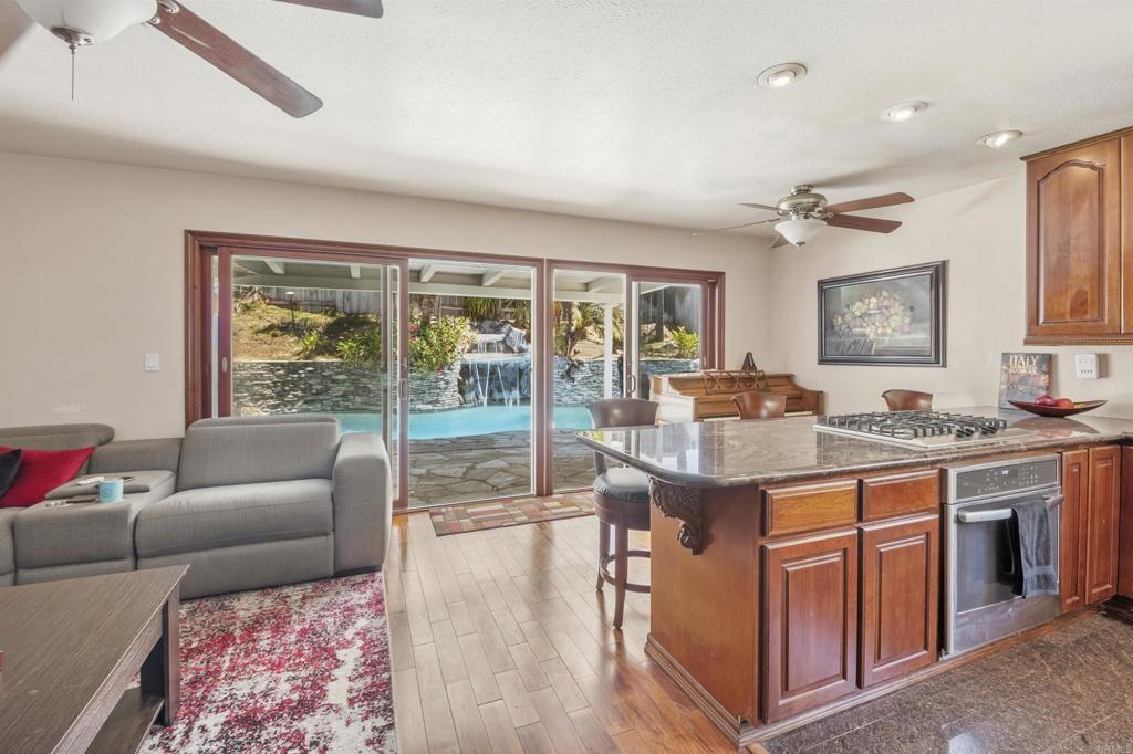 9715 Kenesaw Court Santee, CA 92071 - Photo 4 of 36 a living room with stainless steel appliances granite countertop furniture a couch and a large window