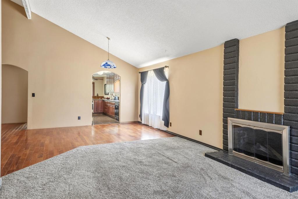 9715 Kenesaw Court Santee, CA 92071 - Photo 8 of 36 a view of empty room with wooden floor and fireplace