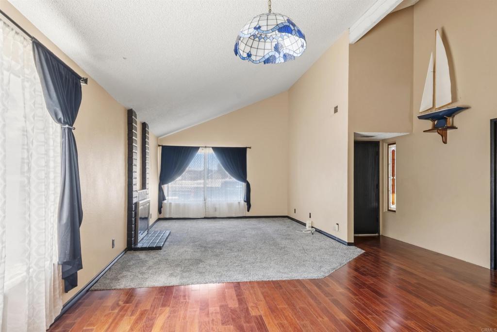 9715 Kenesaw Court Santee, CA 92071 - Photo 9 of 36 an empty room with wooden floor and hallway