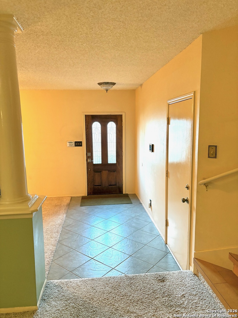 7501 Avery Road Live Oak, TX 78233 - Photo 16 of 32 a view of a hallway with wooden floor and a living room