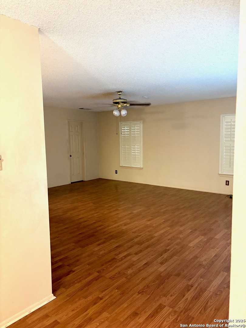 7501 Avery Road Live Oak, TX 78233 - Photo 26 of 32 an empty room with wooden floor and windows