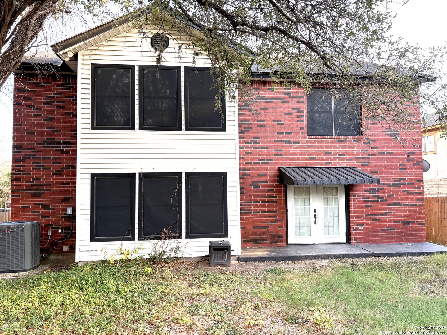 7501 Avery Road Live Oak, TX 78233 - Photo 30 of 32 a front view of a house with a yard and garage