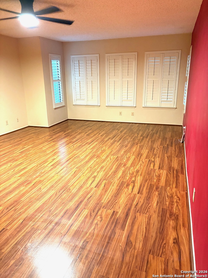 7501 Avery Road Live Oak, TX 78233 - Photo 7 of 32 a view of an empty room with wooden floor and a window