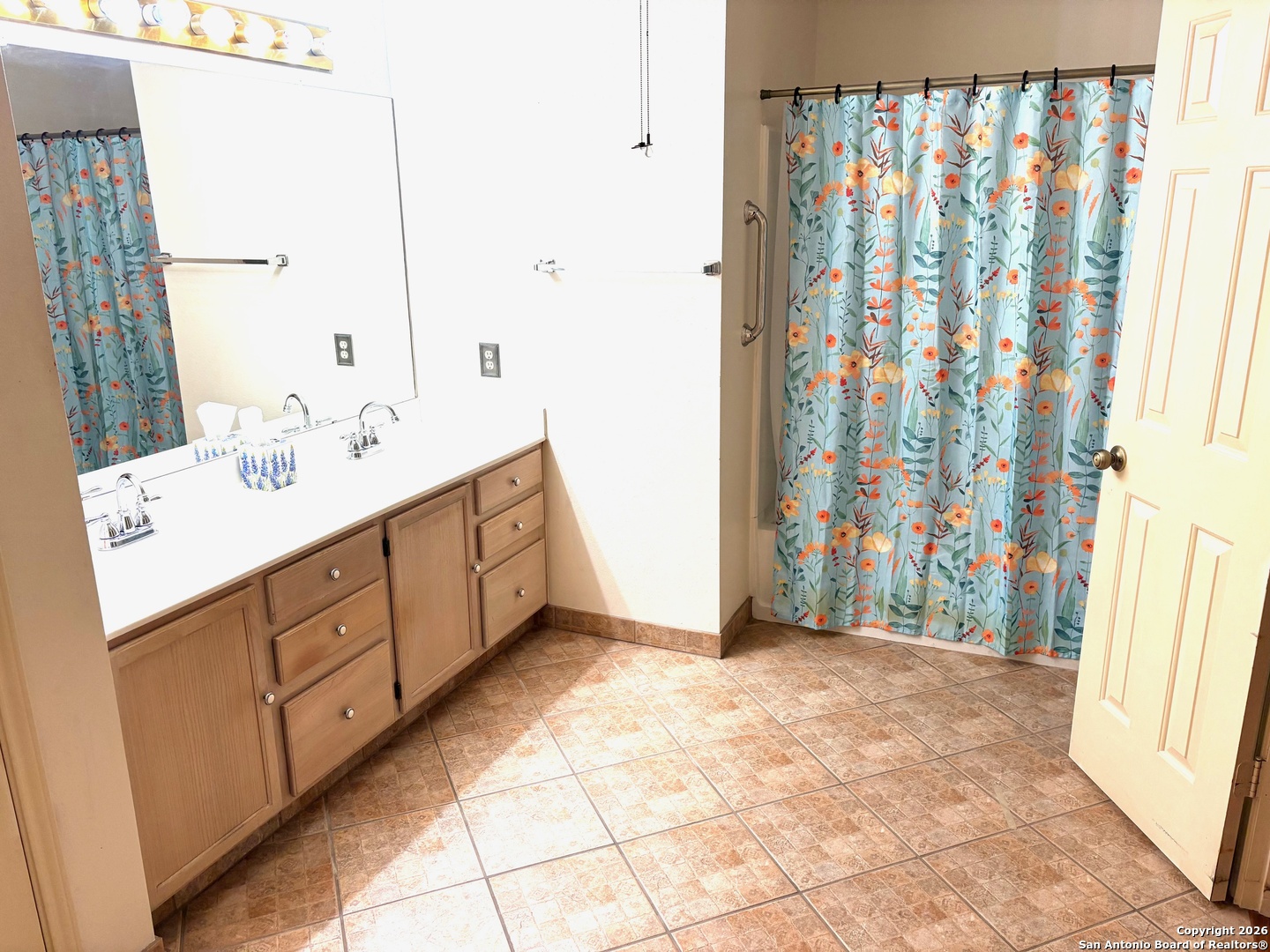 7501 Avery Road Live Oak, TX 78233 - Photo 9 of 32 a bathroom with a double vanity sink and a mirror