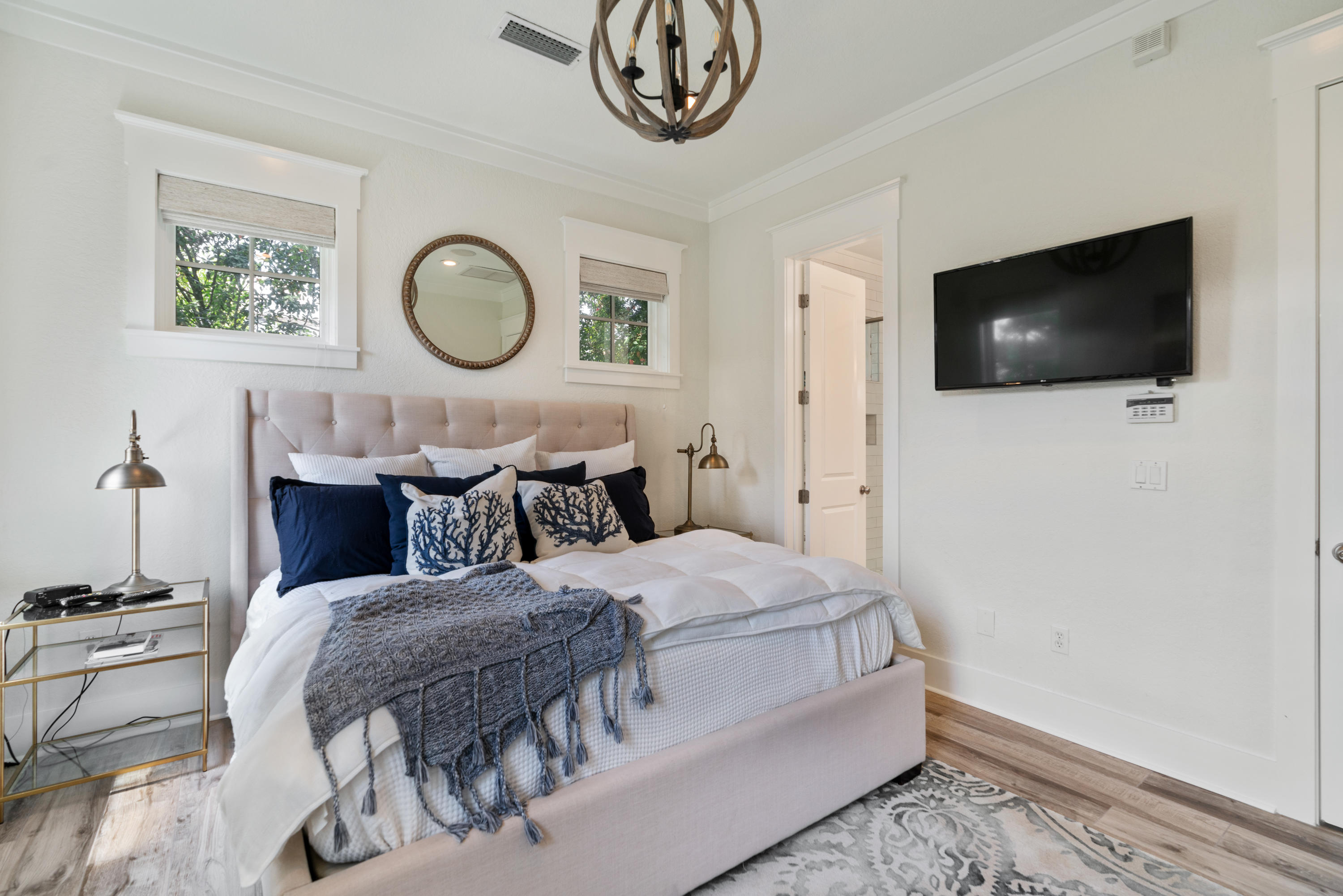 98 Pine Crest Circle Inlet Beach, FL 32461 - Photo 37 of 66 a bedroom with a bed a mirror and a flat tv screen on dresser