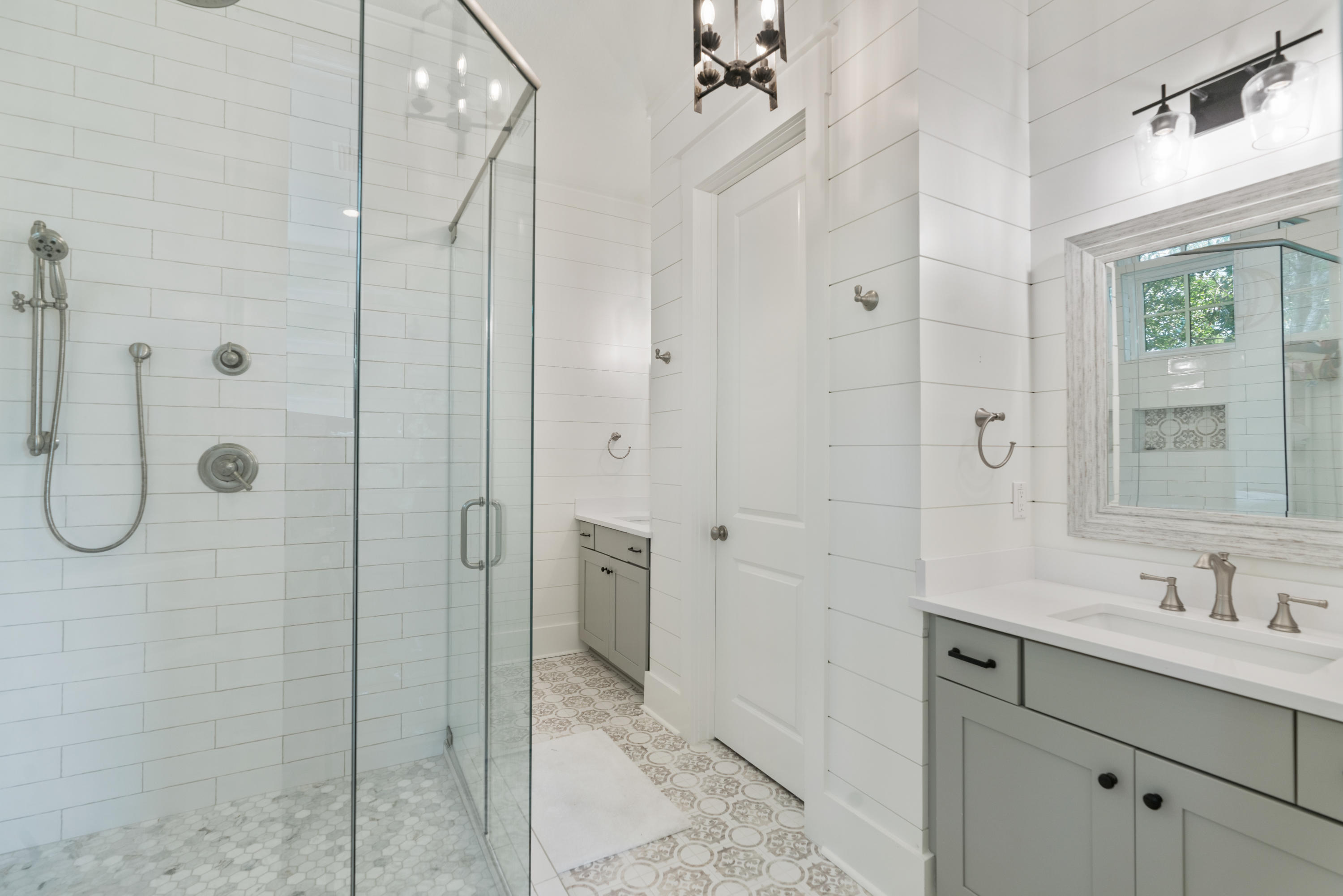 98 Pine Crest Circle Inlet Beach, FL 32461 - Photo 38 of 66 a bathroom with a shower sink and mirror