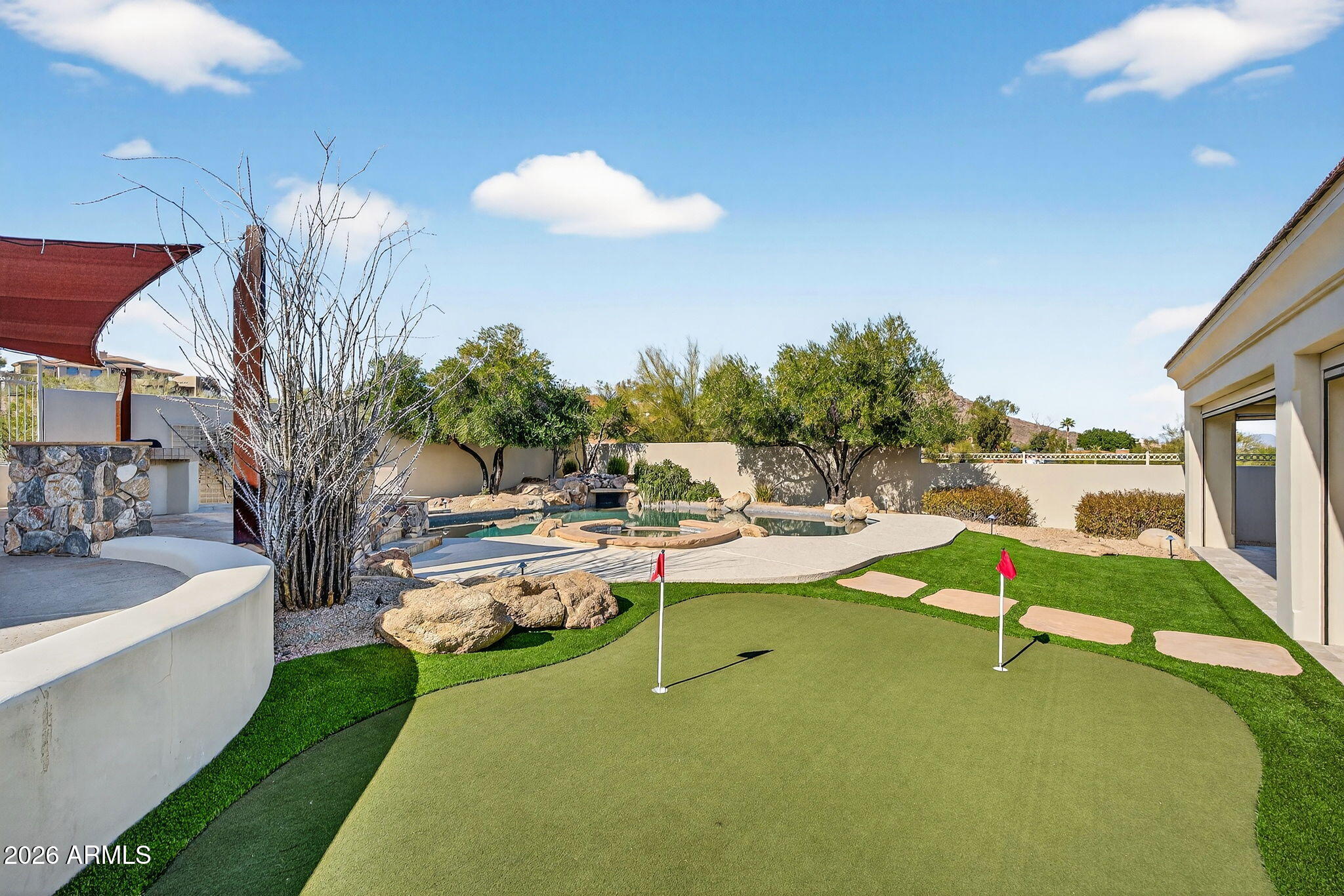 a view of a house with swimming pool and sitting area