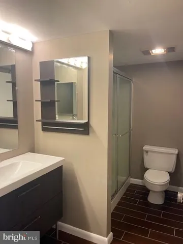 a white toilet sitting next to a bathroom sink