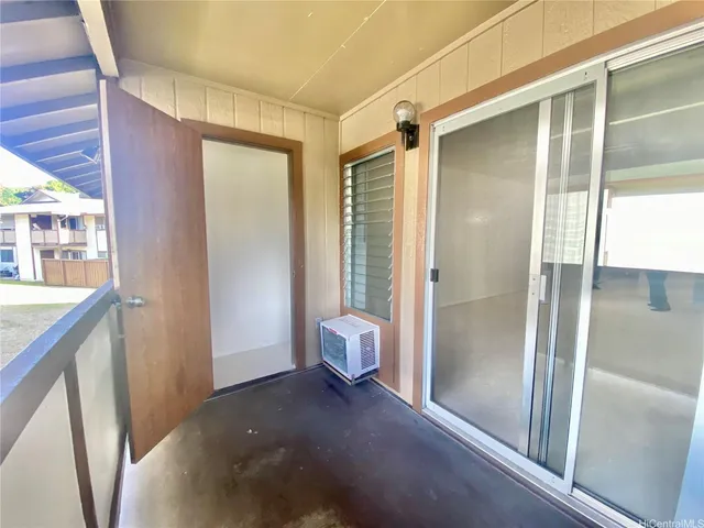 a view of entryway with bathroom and glass door