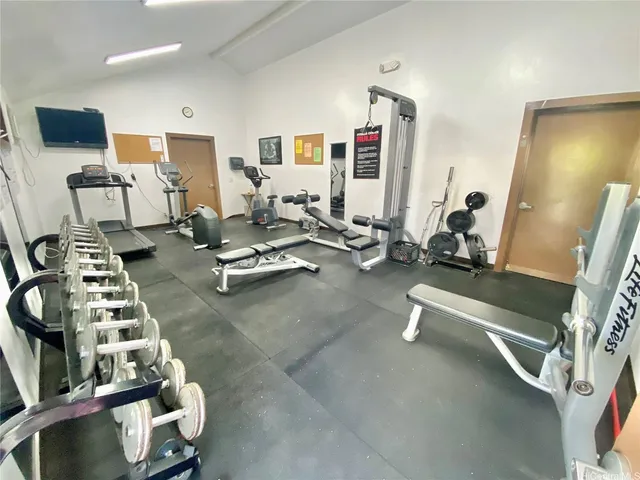 a room with gym equipment and a large mirror