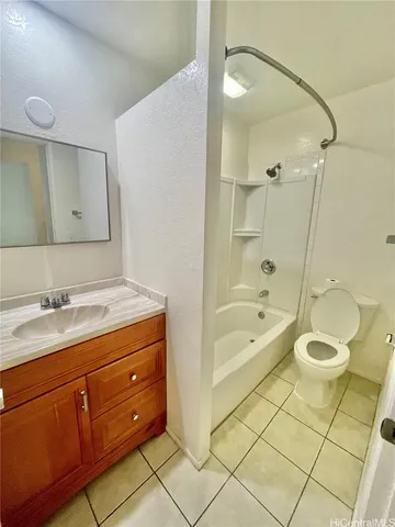 a bathroom with a granite countertop sink a toilet and bathtub