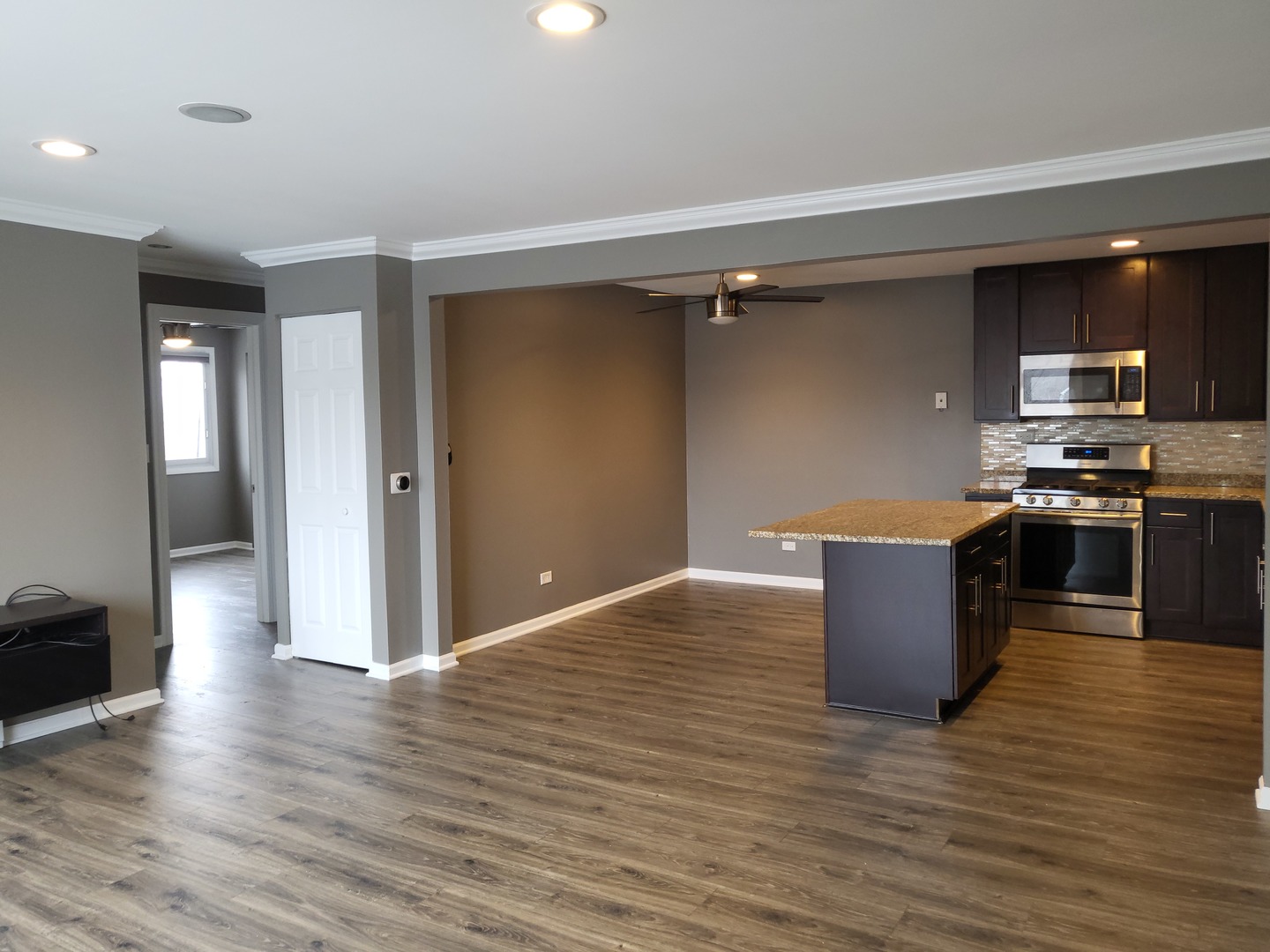 4809 West Engle Road, Unit 3A Alsip, IL 60803 - Photo 11 of 11 a kitchen with stainless steel appliances kitchen island granite countertop a stove top oven and sink
