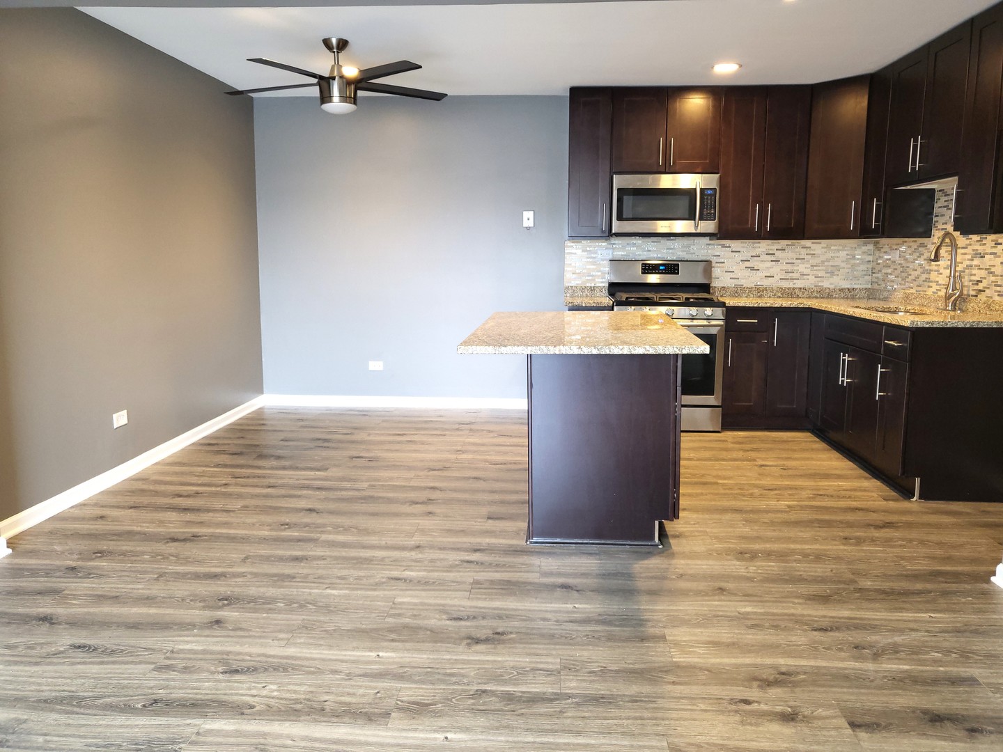 4809 West Engle Road, Unit 3A Alsip, IL 60803 - Photo 3 of 11 a large kitchen with kitchen island a sink counter top space appliances and cabinets