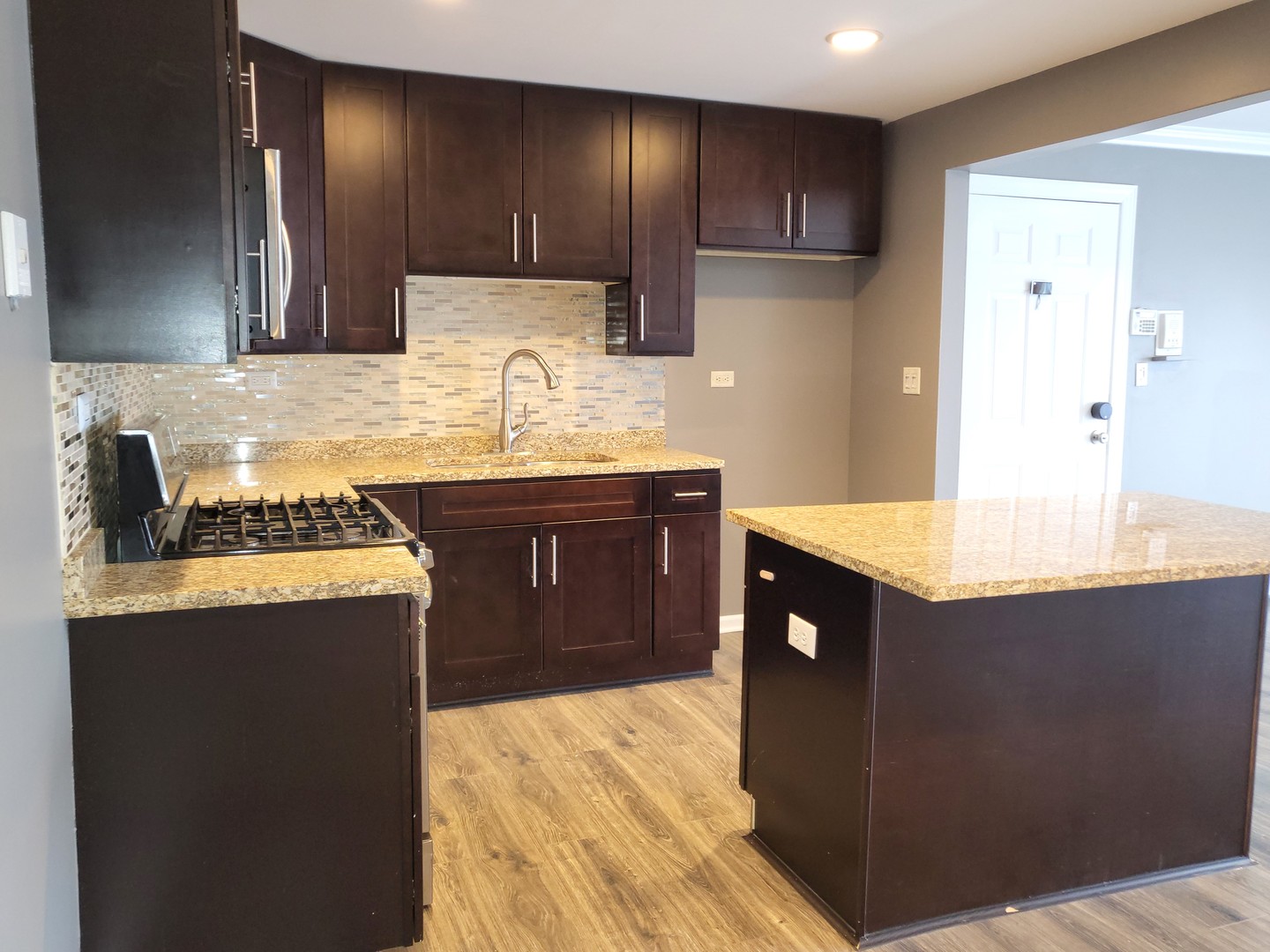 4809 West Engle Road, Unit 3A Alsip, IL 60803 - Photo 4 of 11 a kitchen with kitchen island cabinets and refrigerator