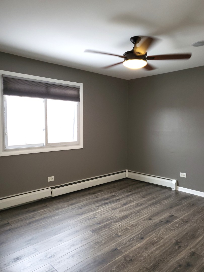 4809 West Engle Road, Unit 3A Alsip, IL 60803 - Photo 6 of 11 a view of an empty room with wooden floor and a window