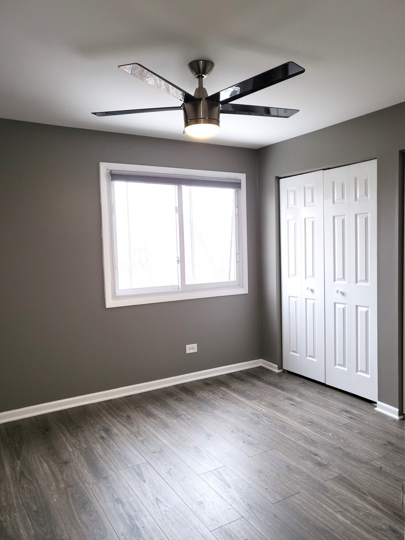4809 West Engle Road, Unit 3A Alsip, IL 60803 - Photo 8 of 11 a view of an empty room with wooden floor and a window