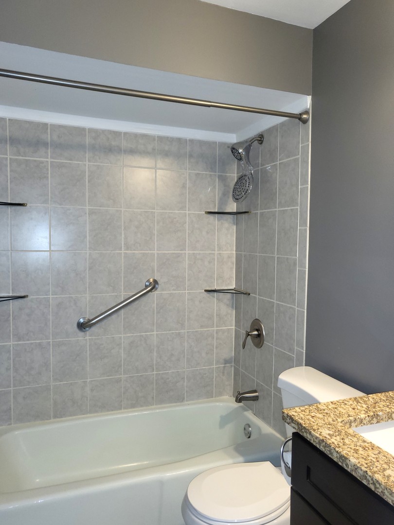 4809 West Engle Road, Unit 3A Alsip, IL 60803 - Photo 9 of 11 a bathroom with a granite countertop toilet sink and shower