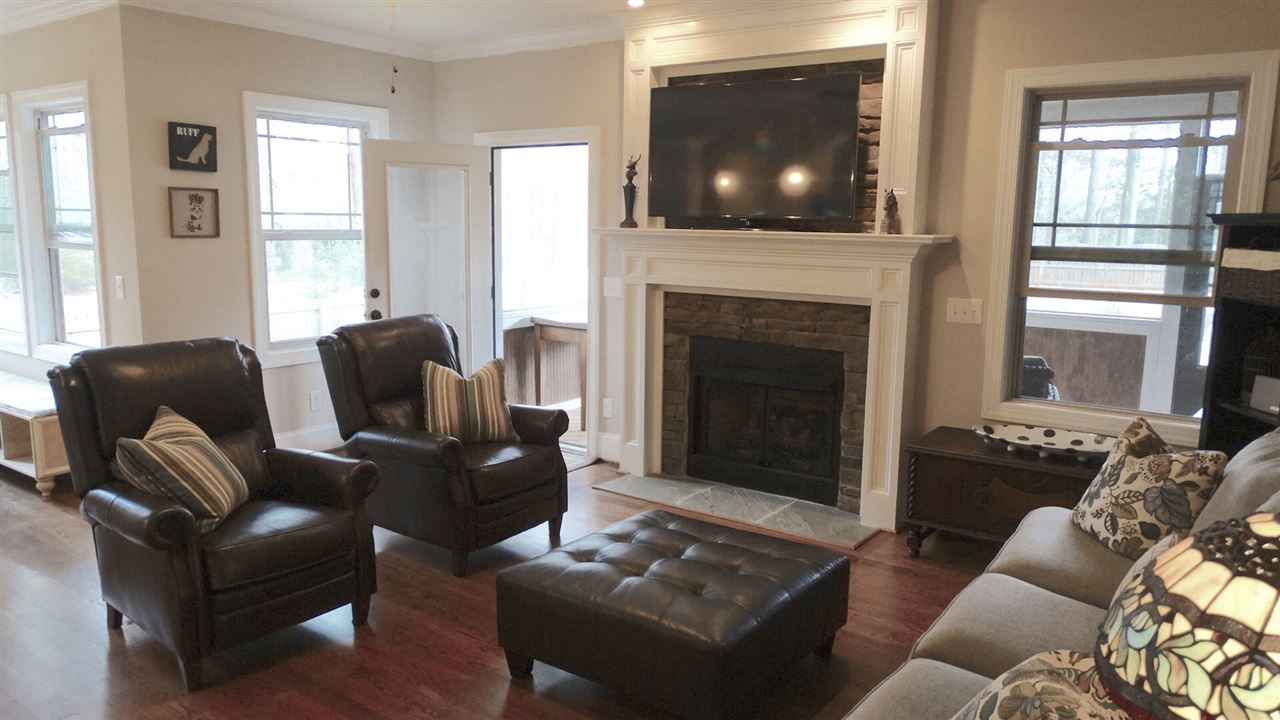 1308 Trinity Circle Raleigh, NC 27607 - Photo 25 of 25 Cozy and warm! Windows, a Gas Fireplace, and an Open Floorplan allows you to interact with the rest of the household both in the amazing Kitchen and also the Bright and Cheery Breakfast Room. Open the door and step out into the Screened Porch. Family Room