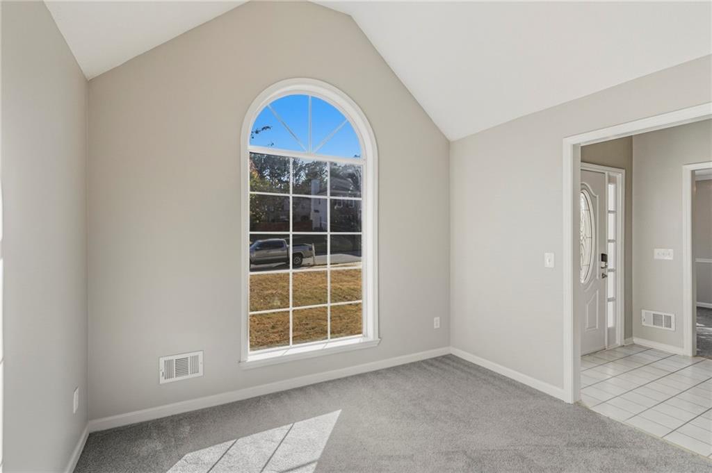 715 Welford Road Northwest Suwanee, GA 30024 - Photo 11 of 50 an empty room with windows