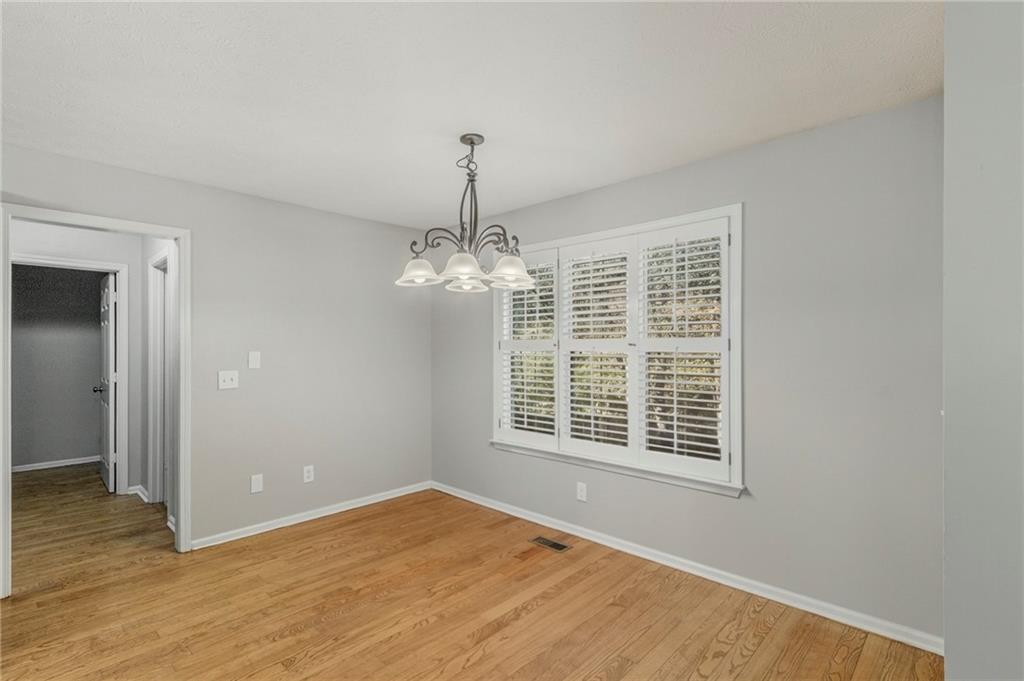715 Welford Road Northwest Suwanee, GA 30024 - Photo 17 of 50 a view of an empty room with wooden floor and a window