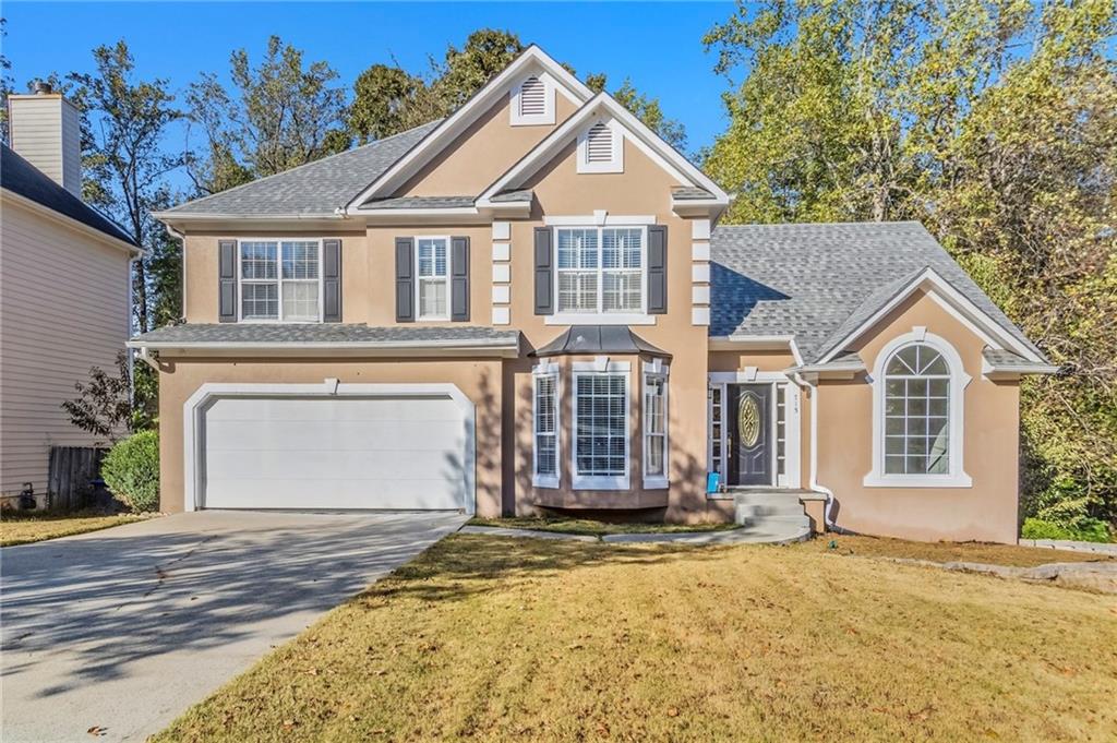 715 Welford Road Northwest Suwanee, GA 30024 - Photo 2 of 50 a front view of a house with a yard