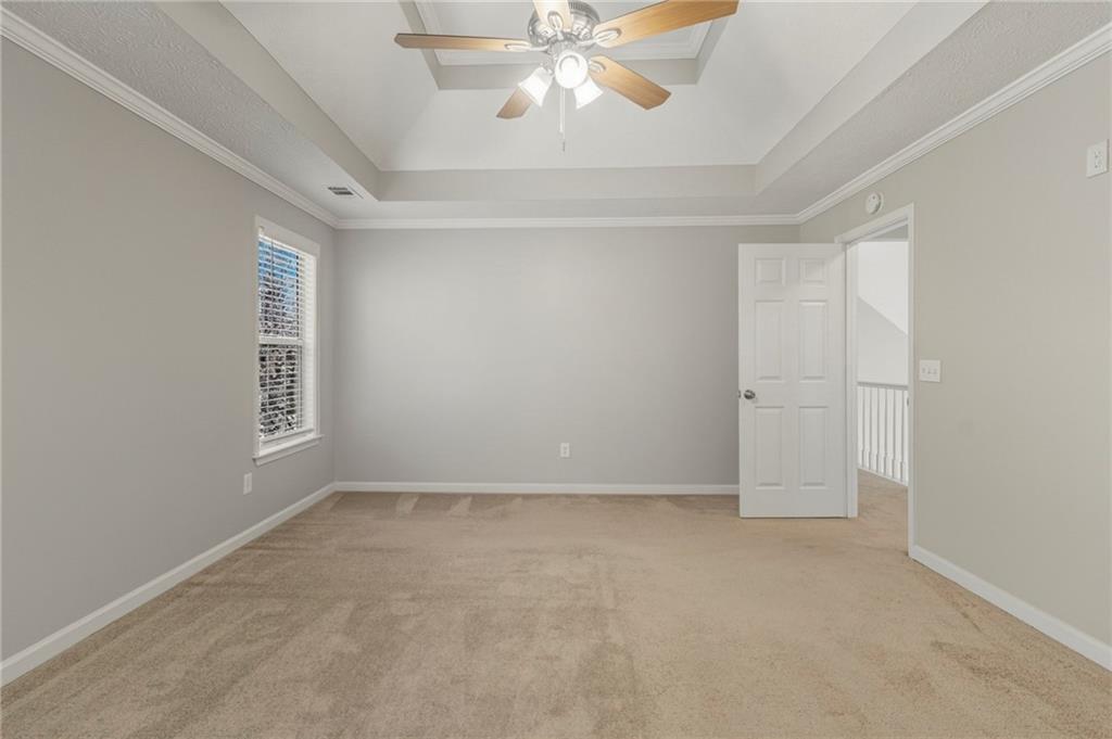 715 Welford Road Northwest Suwanee, GA 30024 - Photo 23 of 50 an empty room with chandelier fan and windows