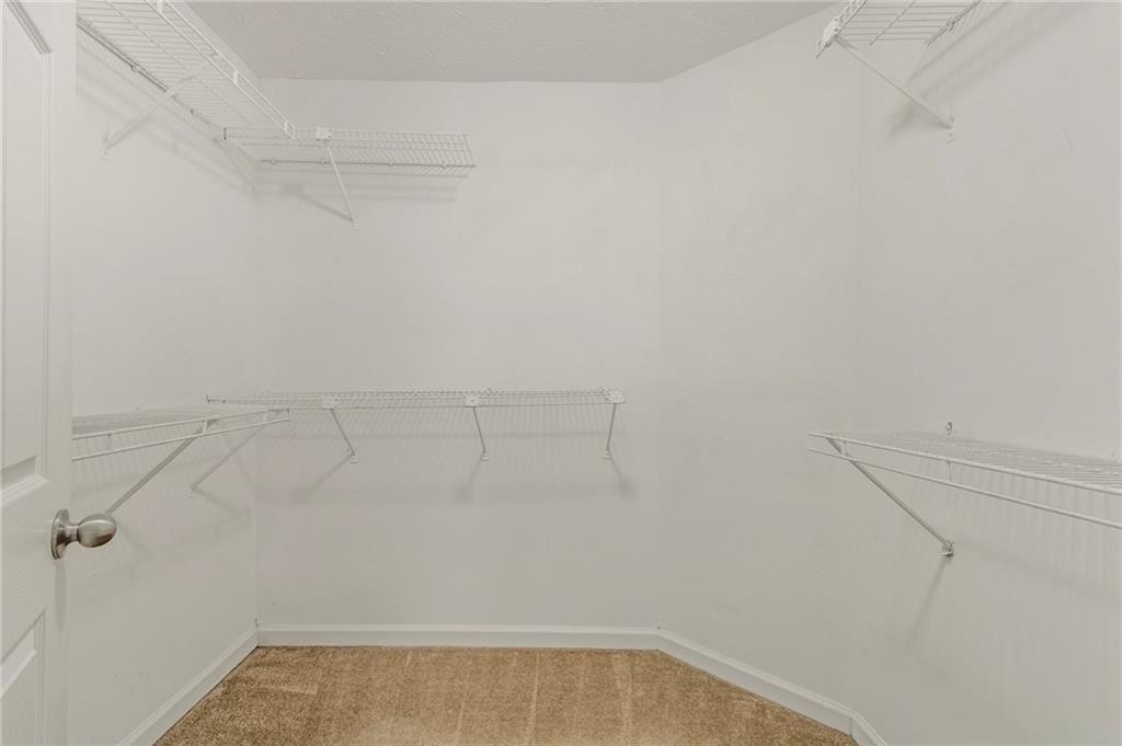 715 Welford Road Northwest Suwanee, GA 30024 - Photo 24 of 50 a view of a room with racks on the wall