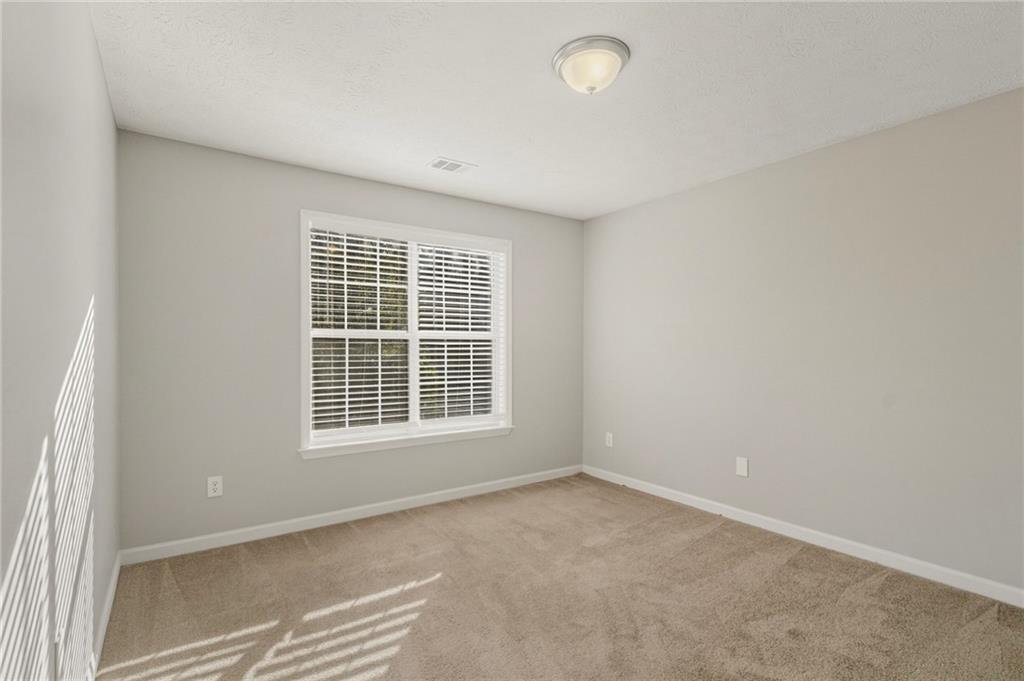 715 Welford Road Northwest Suwanee, GA 30024 - Photo 27 of 50 an empty room with a window