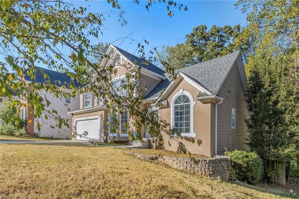 715 Welford Road Northwest Suwanee, GA 30024 - Photo 3 of 50 a view of a house with a yard