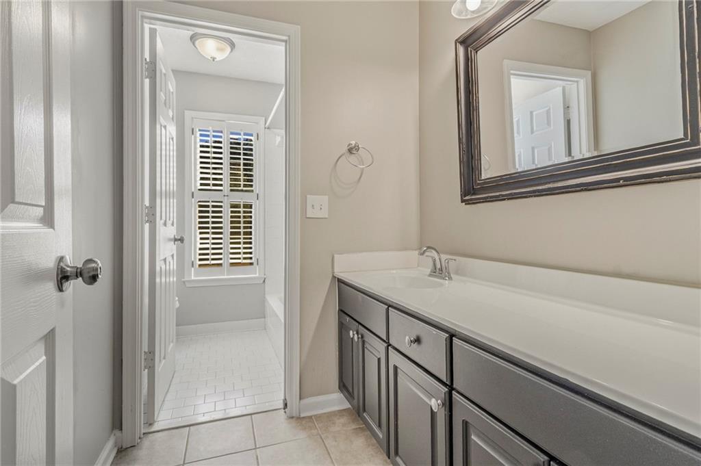 715 Welford Road Northwest Suwanee, GA 30024 - Photo 37 of 50 a bathroom with a sink and a mirror