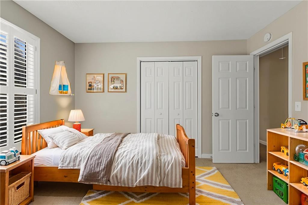 715 Welford Road Northwest Suwanee, GA 30024 - Photo 7 of 50 a bedroom with a bed and a window