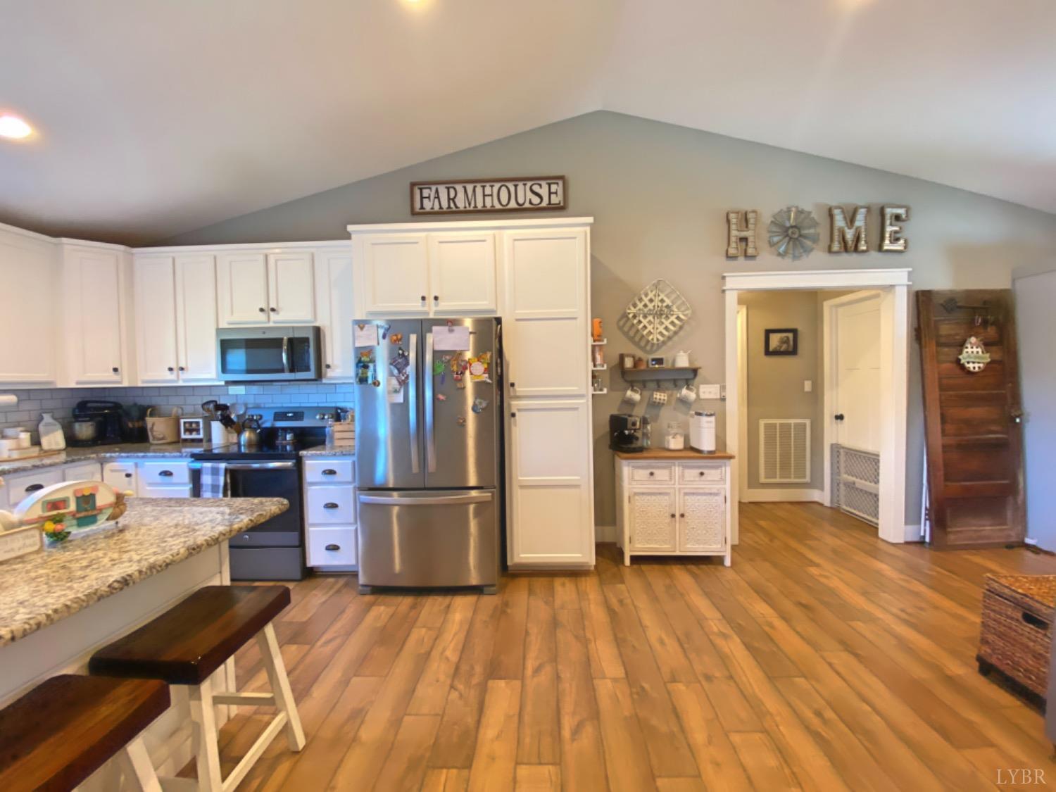 2484 Red House Road Rustburg, VA 24588 - Photo 14 of 29 a kitchen with stainless steel appliances wooden floor and refrigerator