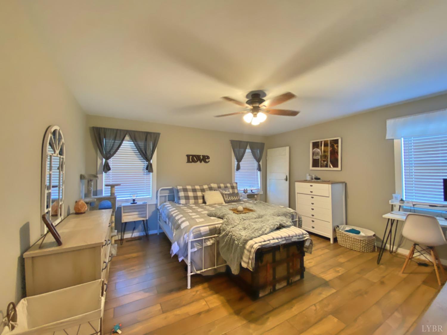 2484 Red House Road Rustburg, VA 24588 - Photo 23 of 29 a bed room with a bed and a chandelier