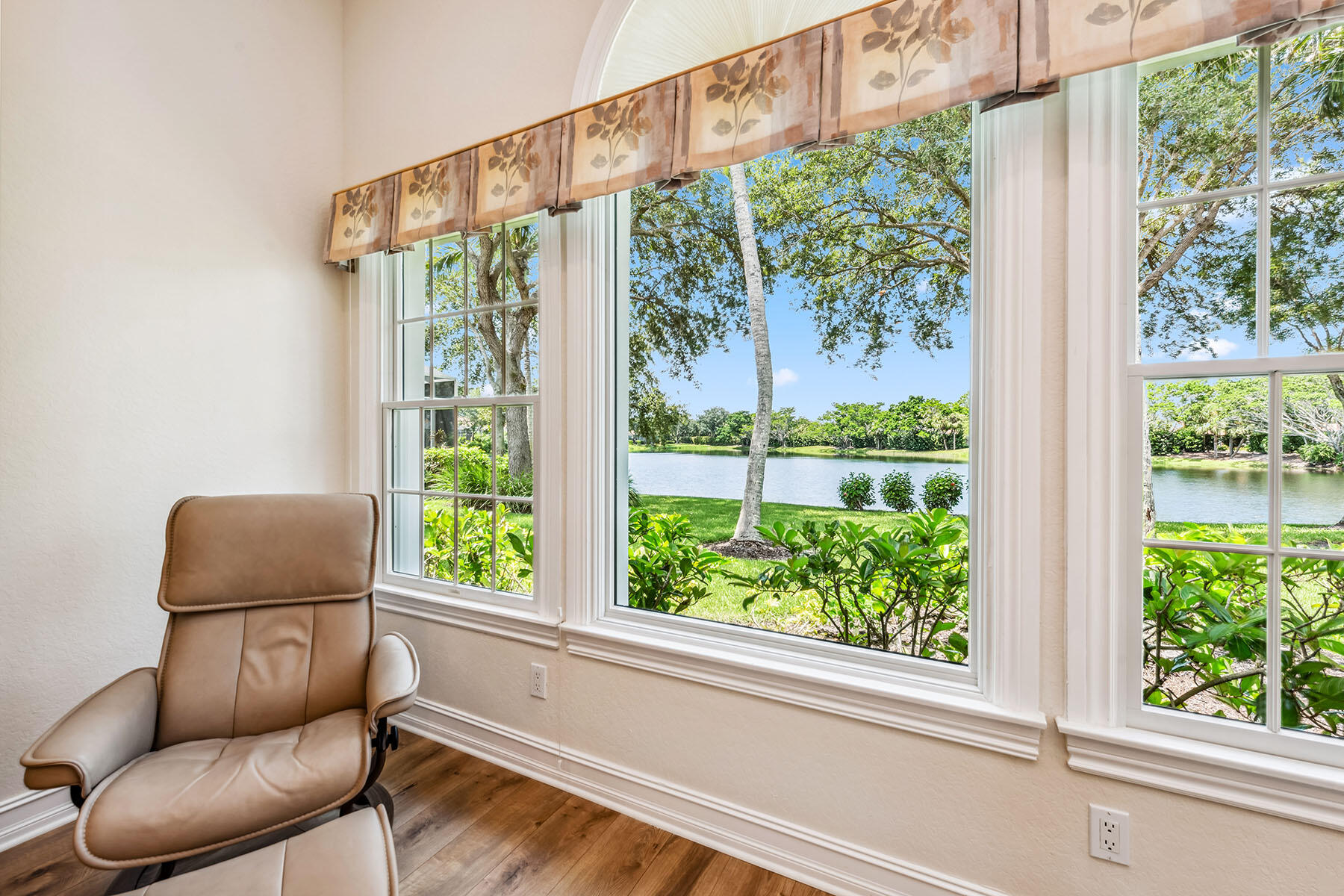 8499 Mallards Way Naples, FL 34114 - Photo 13 of 50 a blue chair sitting in front of a window