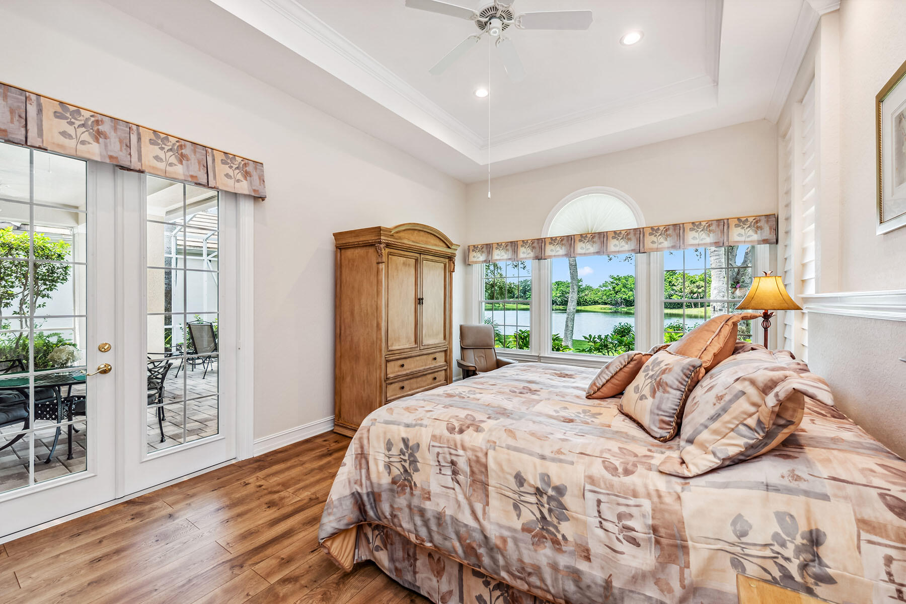 8499 Mallards Way Naples, FL 34114 - Photo 14 of 50 a bed sitting in a bedroom next to a large window