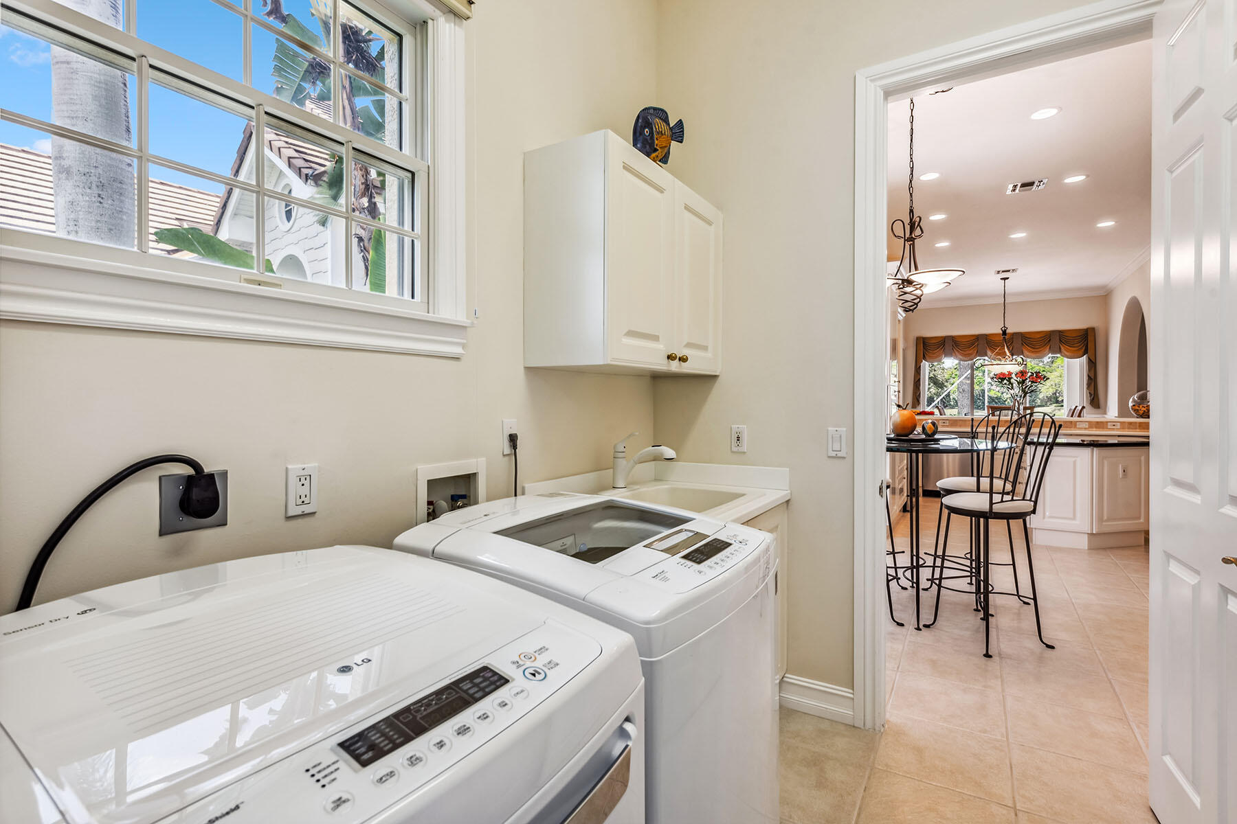8499 Mallards Way Naples, FL 34114 - Photo 20 of 50 a kitchen that has a stove a table and chairs in it