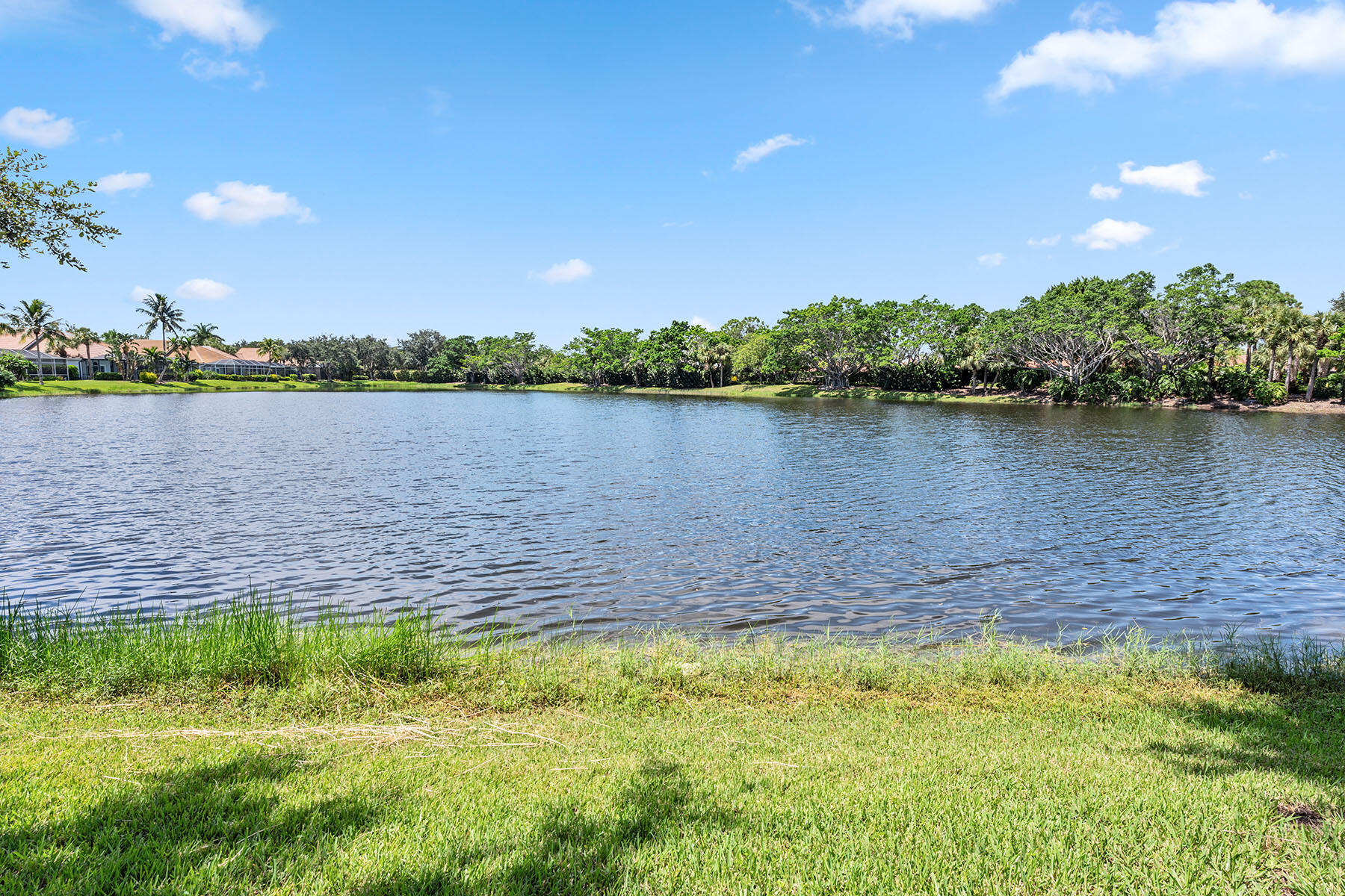 8499 Mallards Way Naples, FL 34114 - Photo 27 of 50 a view of a lake with houses in the back