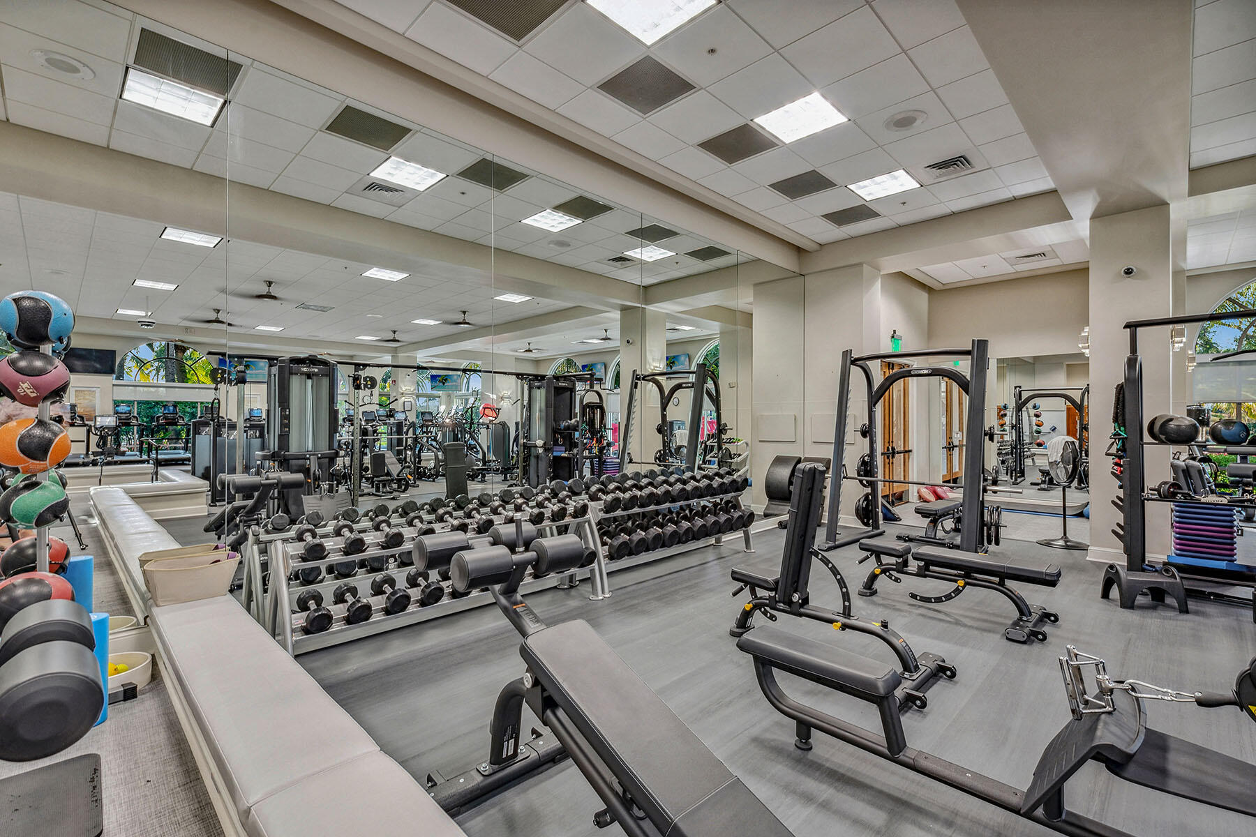 8499 Mallards Way Naples, FL 34114 - Photo 46 of 50 a room with gym equipment and lots of wooden walls