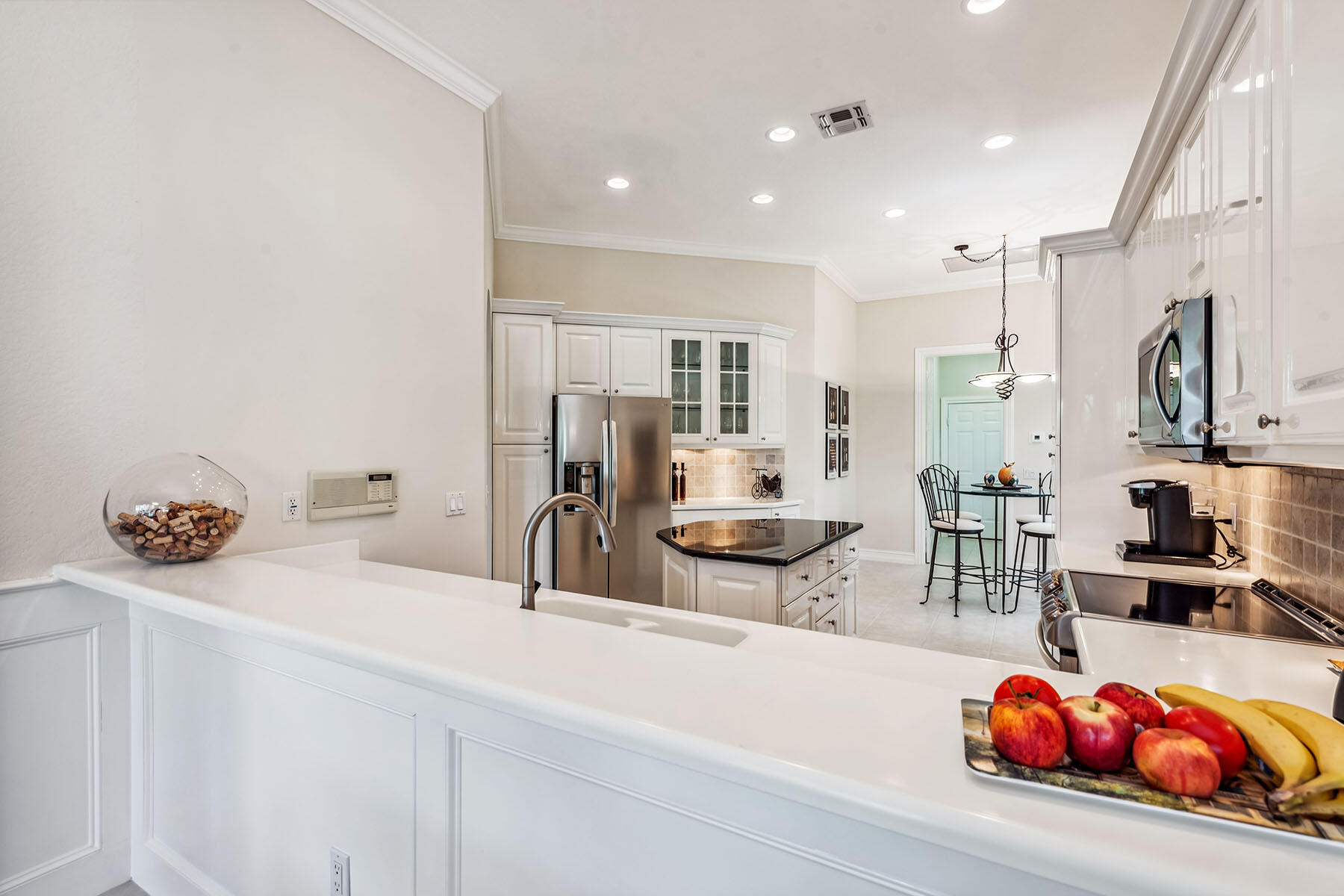8499 Mallards Way Naples, FL 34114 - Photo 7 of 50 a kitchen with stainless steel appliances a sink and a refrigerator