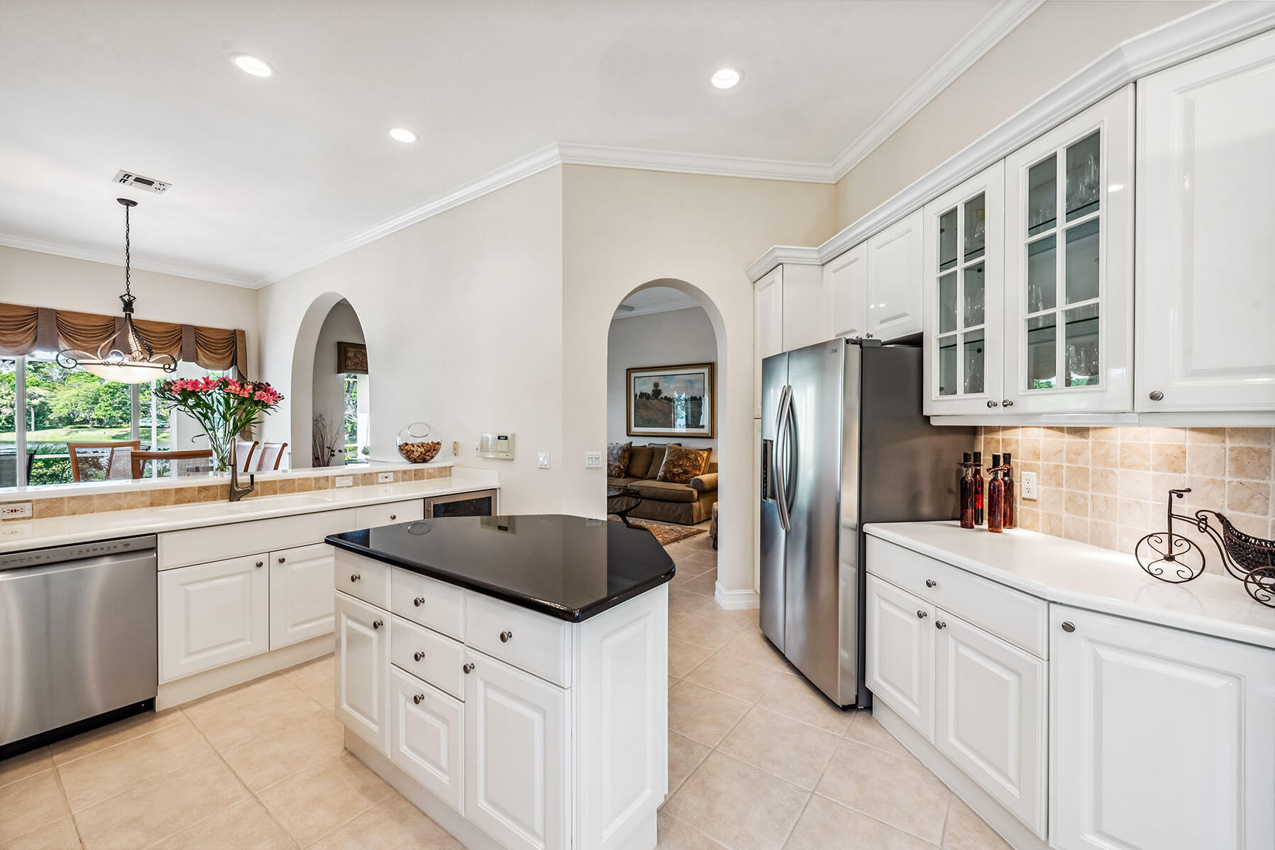 8499 Mallards Way Naples, FL 34114 - Photo 8 of 50 a kitchen with stainless steel appliances granite countertop a refrigerator a sink and white cabinets