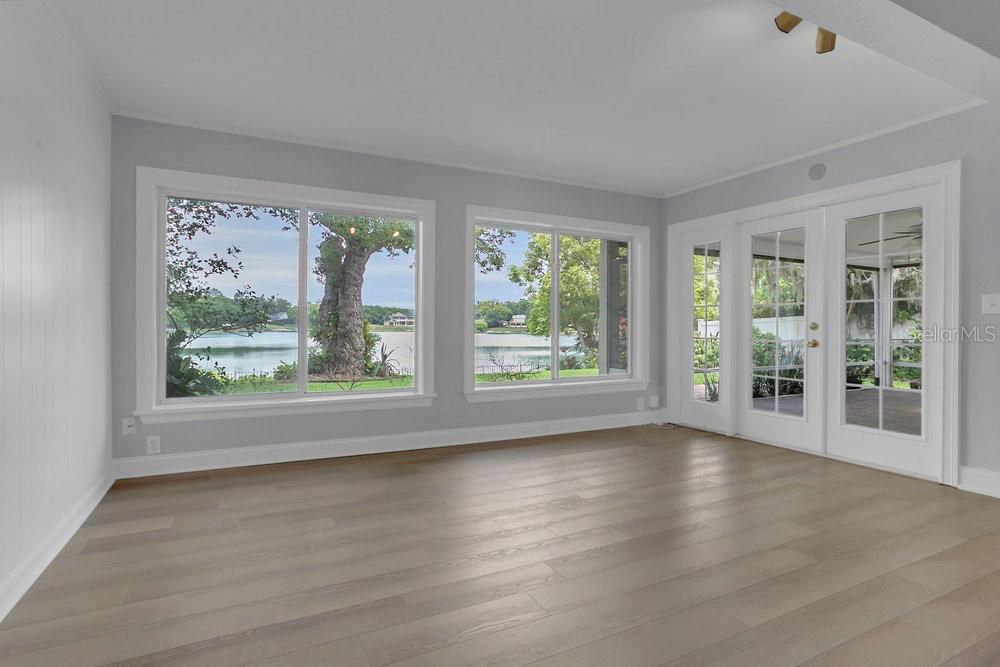 3605 Pershing Avenue Orlando, FL 32812 - Photo 13 of 35 a view of an empty room with wooden floor and a window
