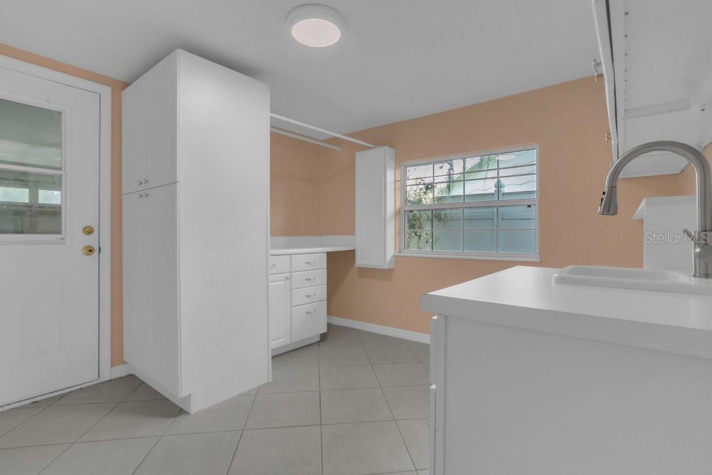 3605 Pershing Avenue Orlando, FL 32812 - Photo 23 of 35 a kitchen with cabinets and window